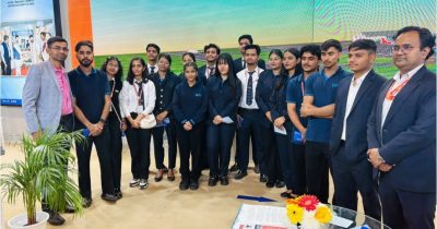 Students studying a detailed scale model of an airport layout — understanding the spatial planning and infrastructure behind modern aviation facilities.