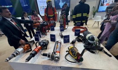 Aviation safety and rescue equipment on display — hydraulic spreaders, cutters, telescopic bars, and breathing apparatus used in airport emergency response operations.