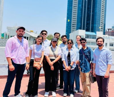 Students from Aharada Education gathered outside — the iconic skyline of the visit location forming the backdrop of an unforgettable learning day.