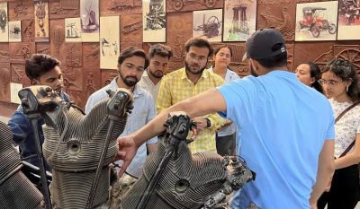 A guide explains the intricate mechanics of a radial aircraft engine — students leaning in, absorbing the engineering principles that powered aviation's early era.