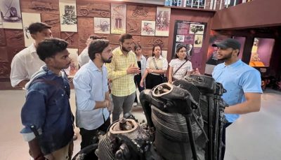 Students engaged in a lively discussion around the engine exhibit — questions flying as fast as the aircraft these machines once powered.